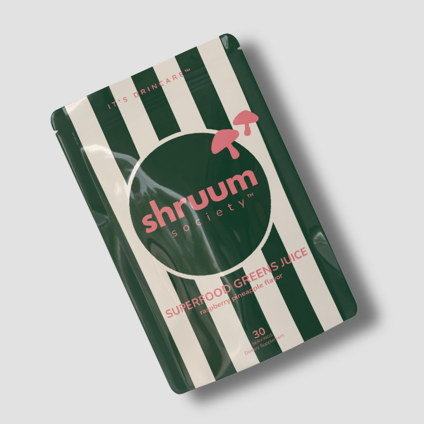 Shruum Society superfood greens juice package with green and white striped design on a light gray background