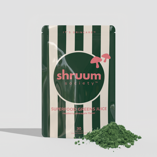 Shruum Society superfood greens juice package with green powder on a light gray background
